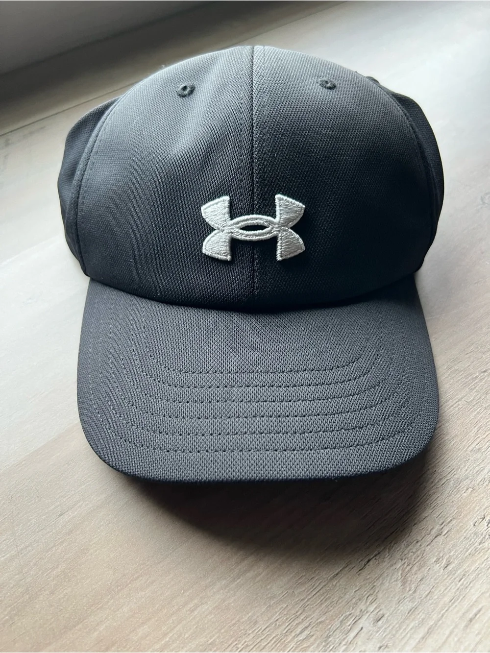 Ladies Under Armour Ponytail Black Cap with White Embroidered Logo